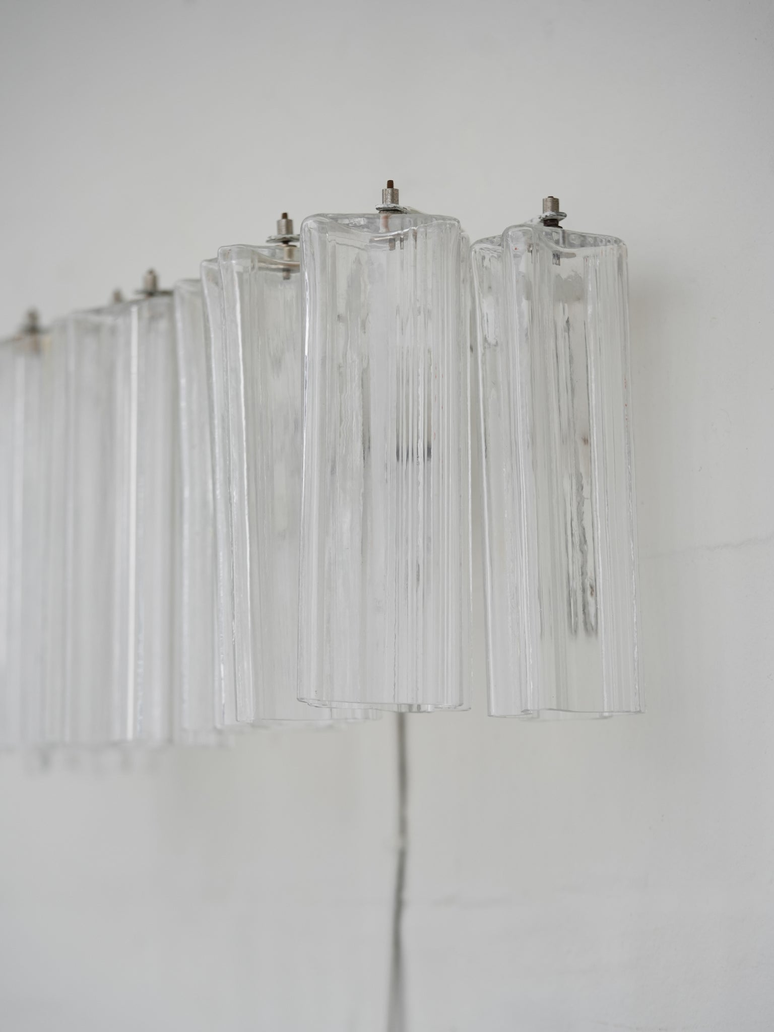 Pair of vintage Venini wall lights in clear Murano glass with a metal frame, crafted in Italy, 1960s. Available at RUE VERTE, Copenhagen's destination for vintage and contemporary art, lighting and furniture.